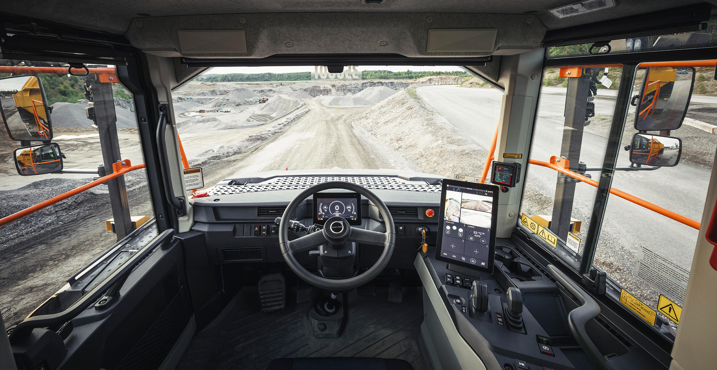 Driver’s eye view inside the cab of a Volvo Articulated Hauler showing the steering wheel and integrated Co-Pilot.
