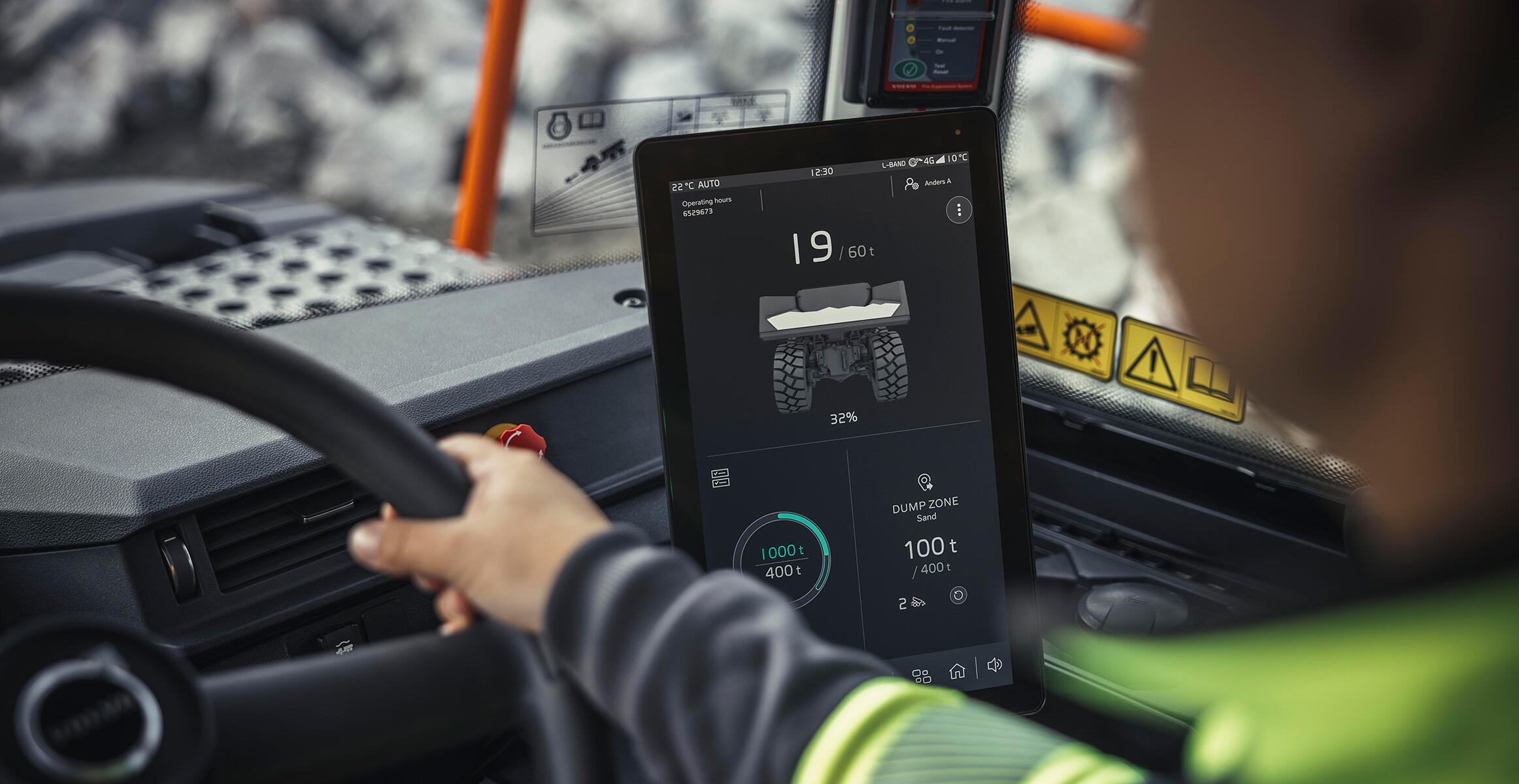 Close up of the operator’s face and hands on the steering wheel of a Volvo Articulated Hauler with Haul Assist functionality on the integrated Co-Pilot