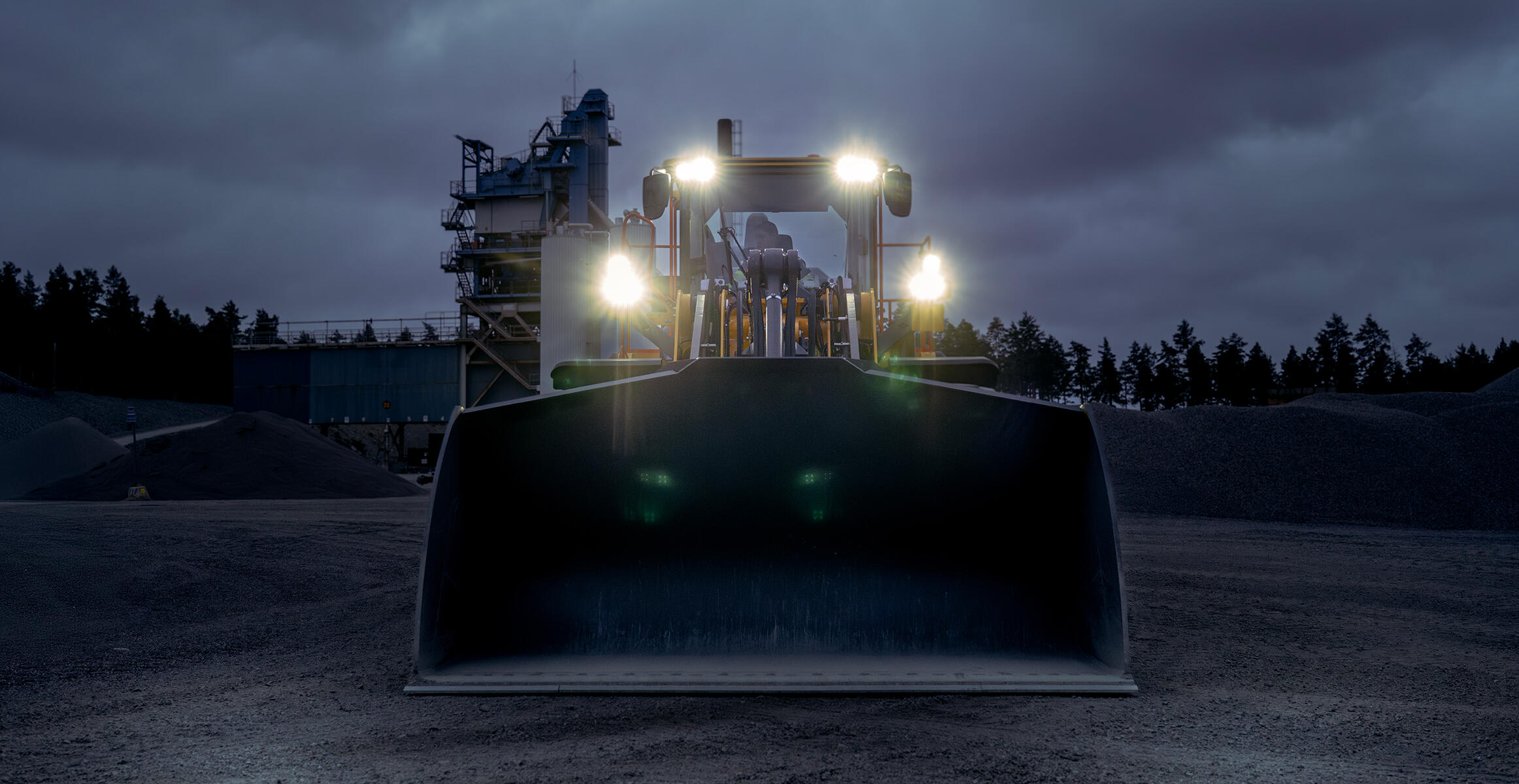 Volvo L180 wheel loader at night with lights on