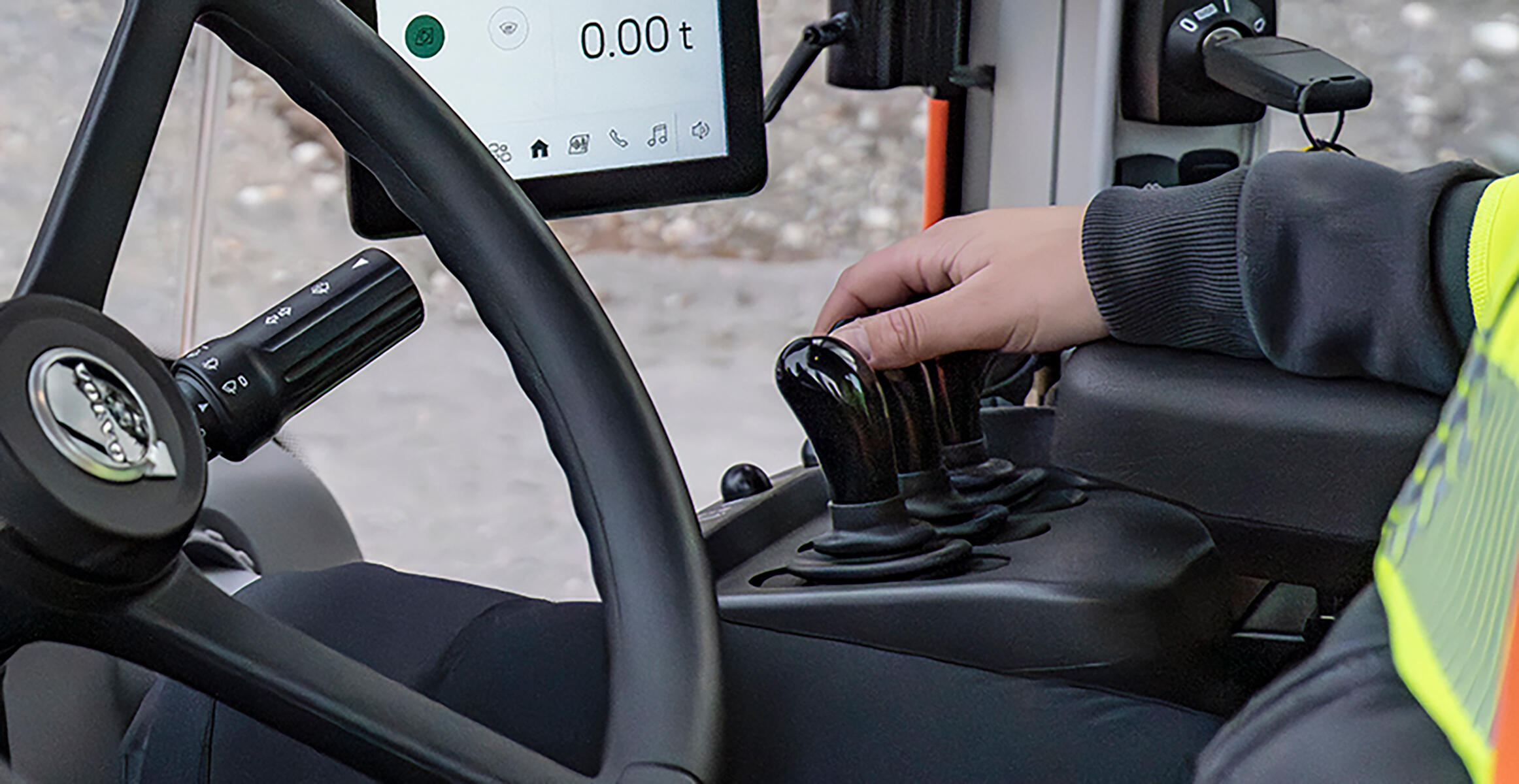 Operator hands on the controls in Volvo L180 wheel loader