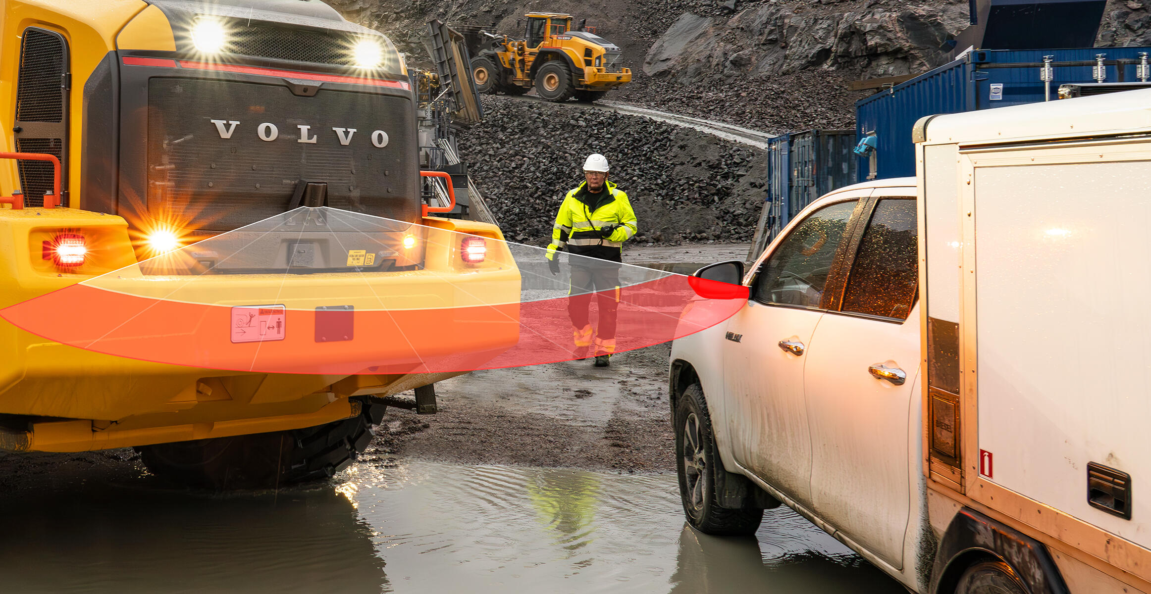 Collision mitigation system alerts a Volvo wheel loader to the danger of a parked service van