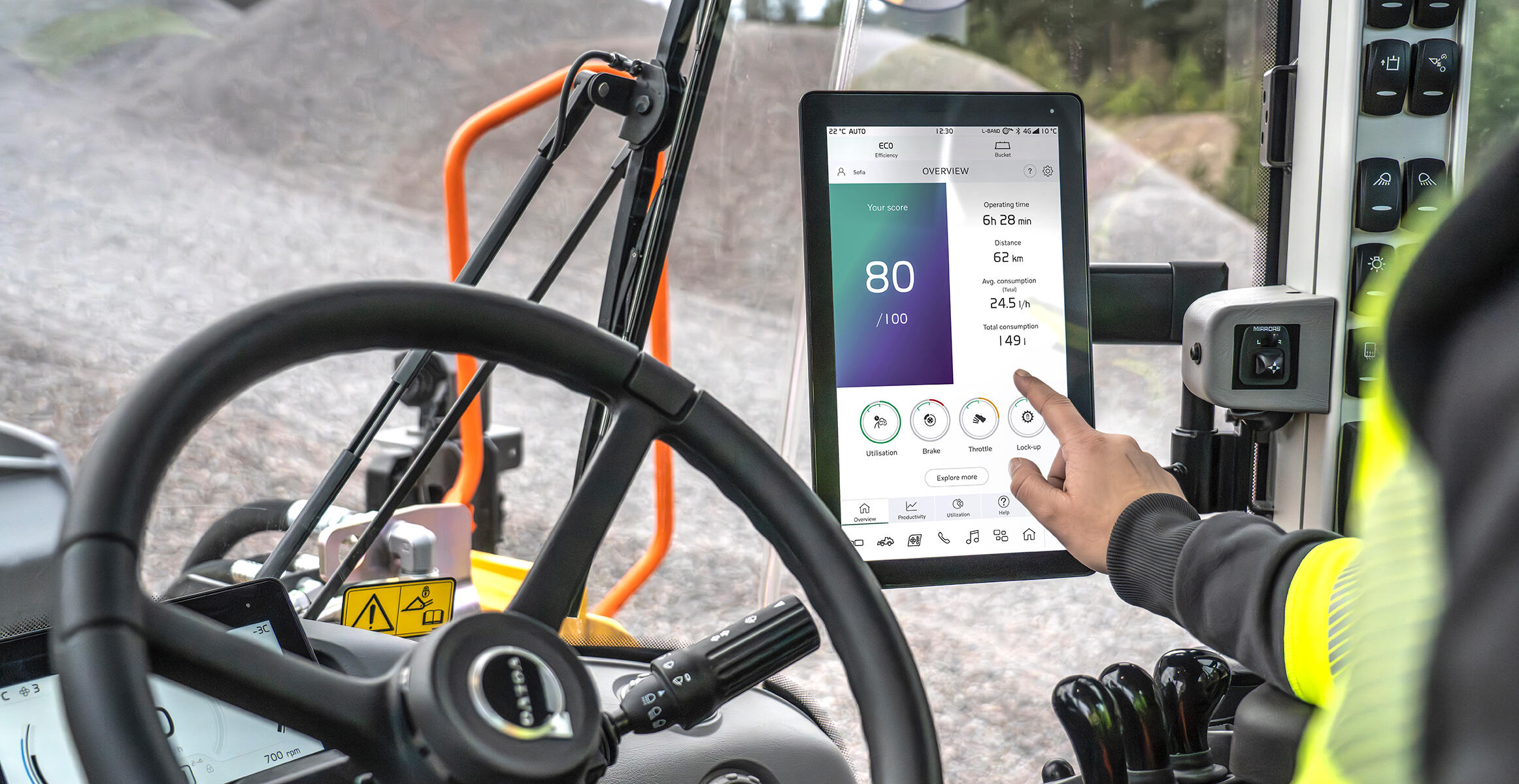 Close-up of operator touching screen of Volvo Co-Pilot with Operator Coaching app on screen