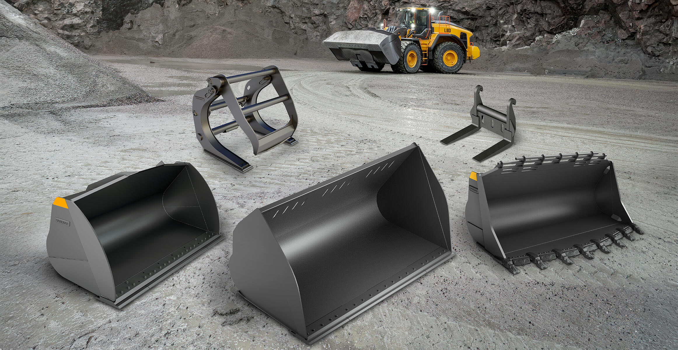 Buckets, grab and forks positioned in front of Volvo L180 wheel loader in a quarry