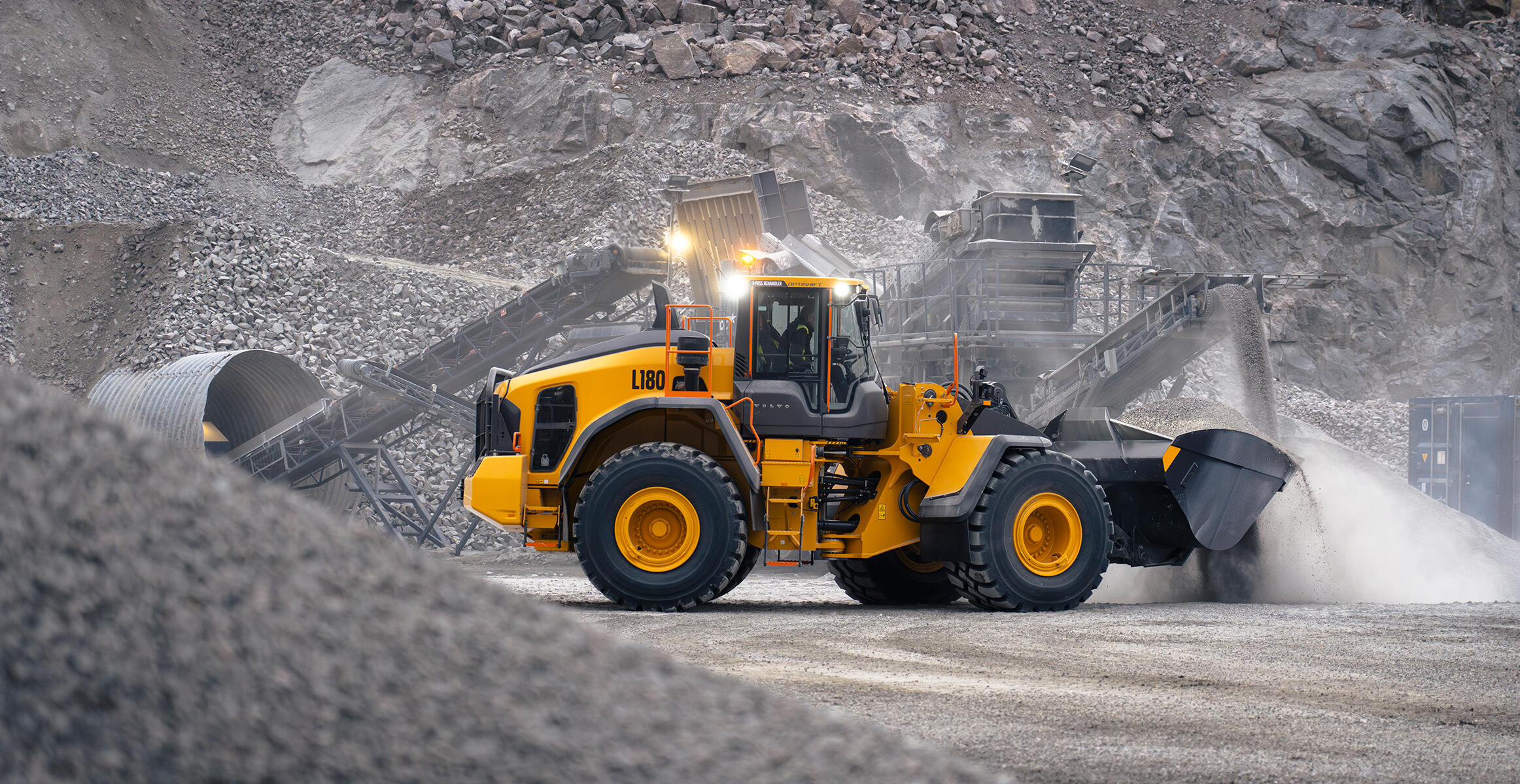 Volvo L180 wheel loader working in dusty quarry environment