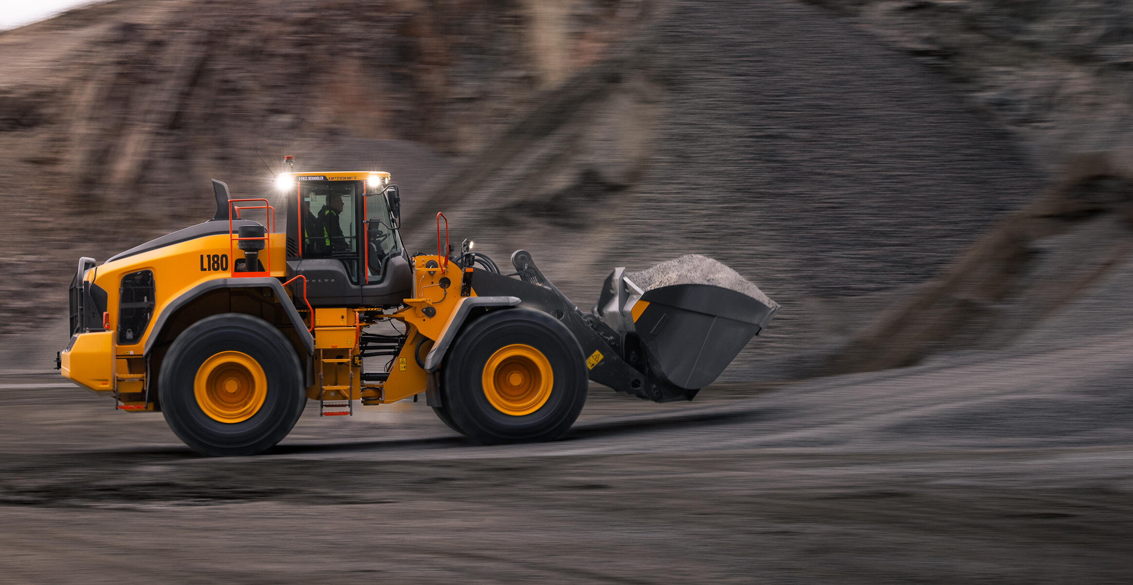 Volvo L180 wheel loader travelling with a full bucket in a quarry Volvo