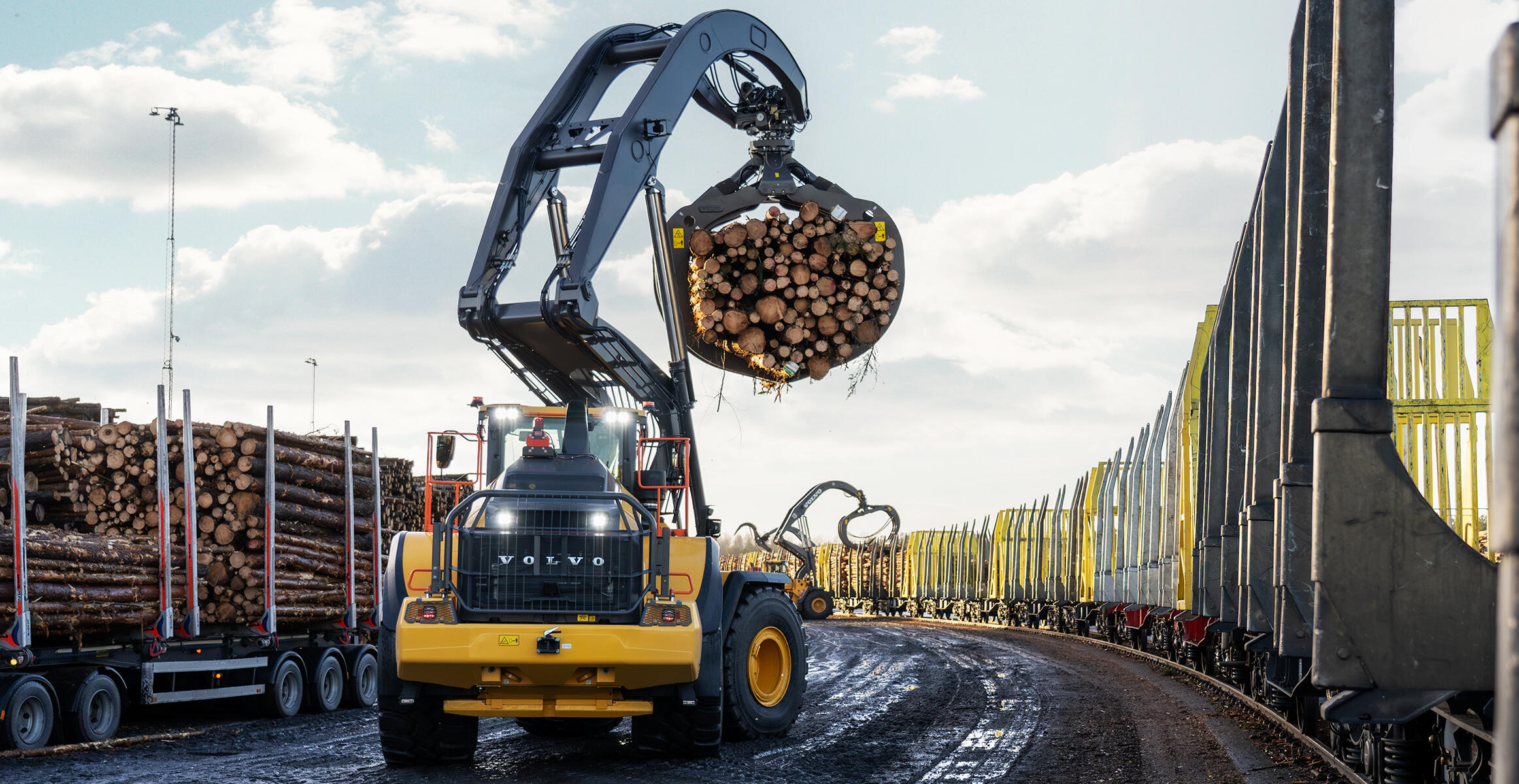 Volvo L200 High Lift log handler carrying load of logs at height