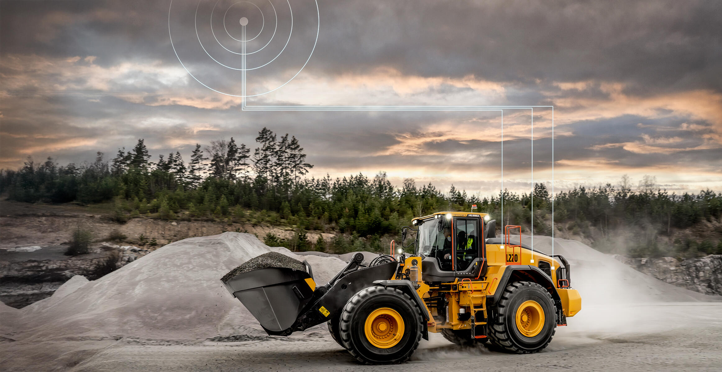 Volvo L220 wheel loader travelling through quarry. Connectivity graphic above it illustrates connection with CareTrack telematics