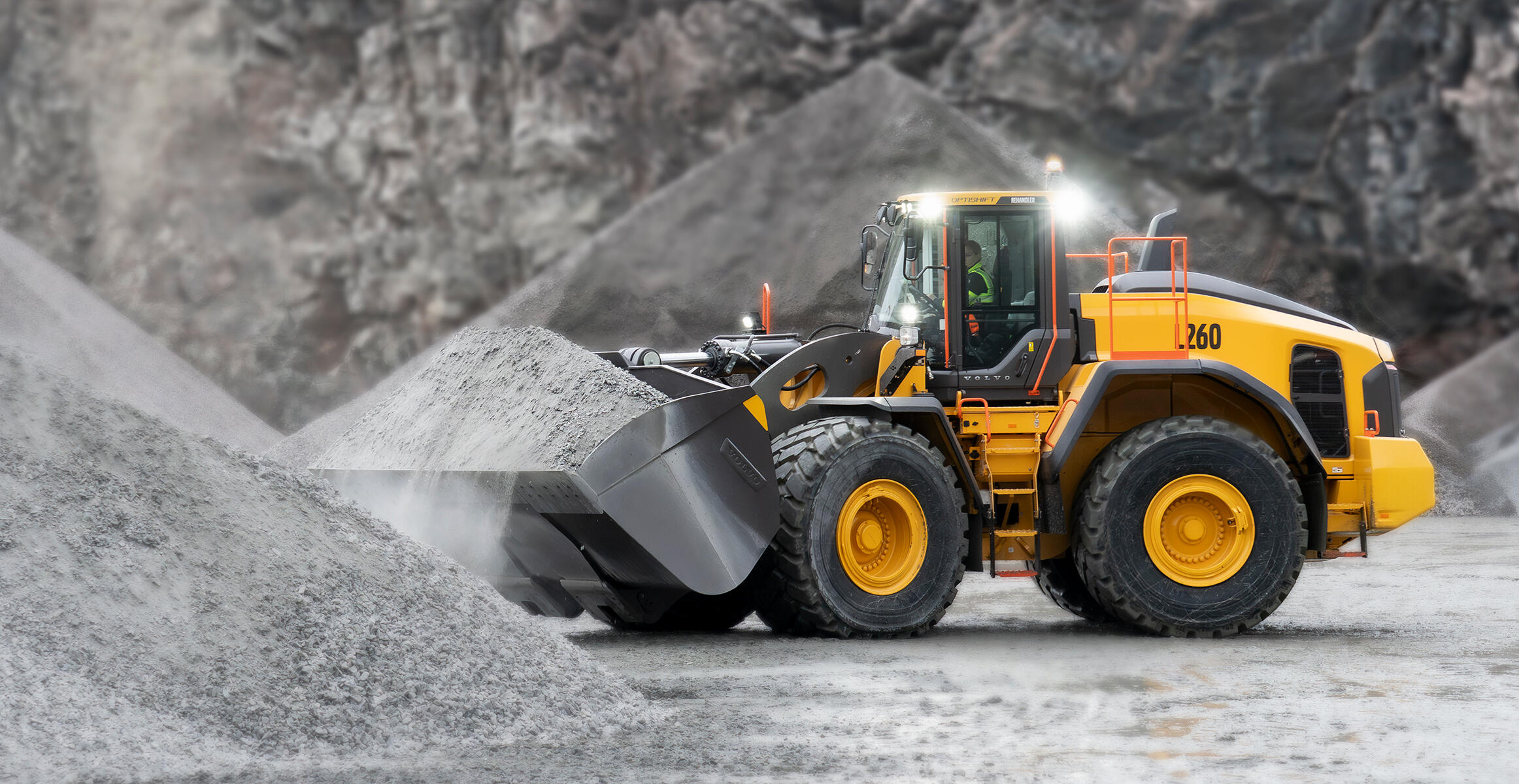 Volvo L260 wheel loader loading from pile in quarry at night