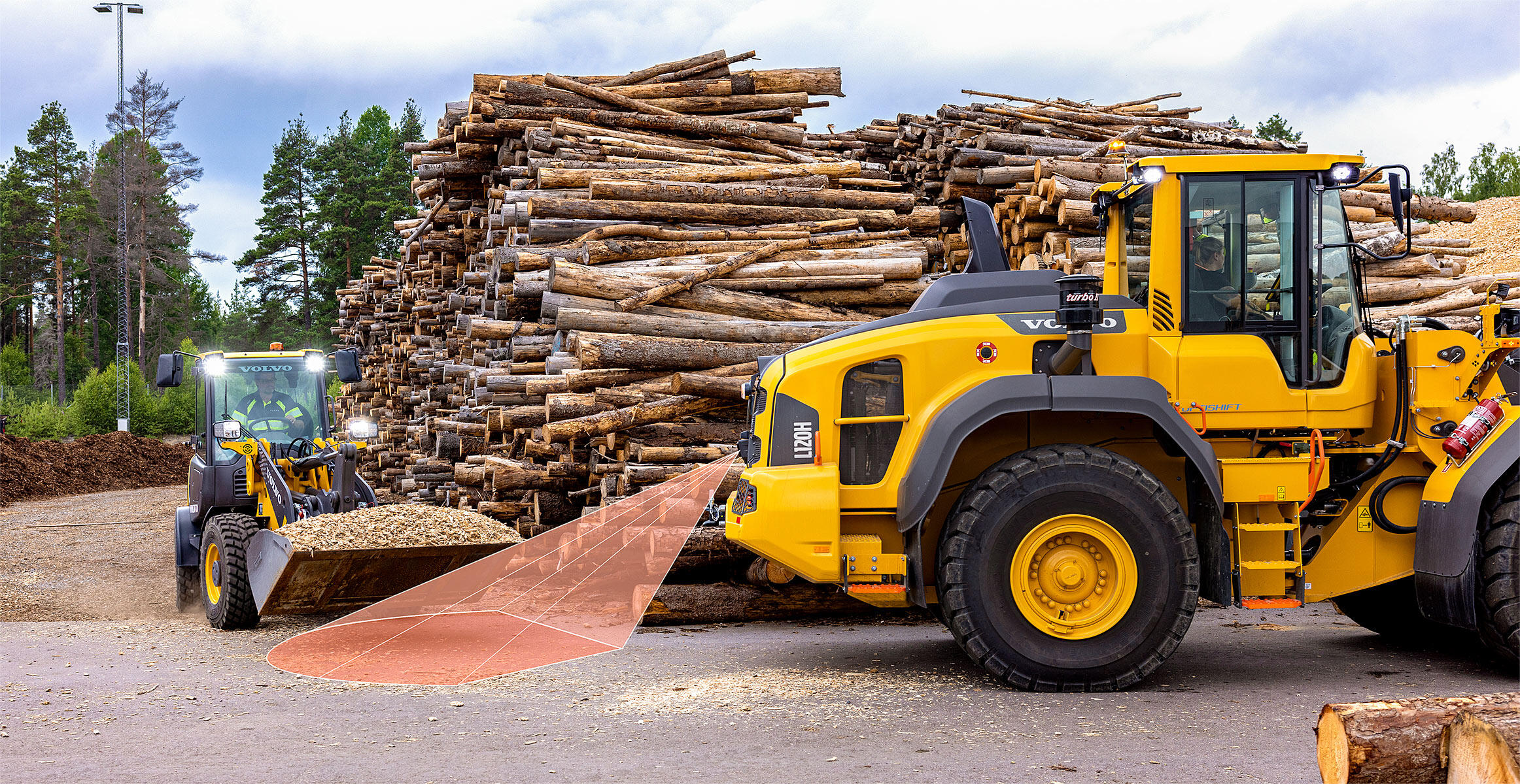 A simulated picture of the collision mitigation system in action while a L110H or L120H working in reverse will automatically applying the brakes when the machine approaches an obstacle.